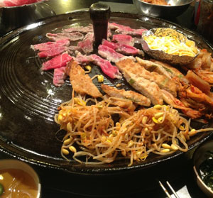 Beef brisket is grilled with korean pancake, kimchi, and bean sprouts for "Set B" at Honey Pig BBQ.<br>Photo Credit: Tamara Navarro
