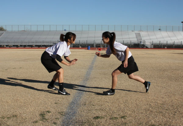 Sophomores Alyssa Bui and Jen Chiang practice plays on the field before their first game. Photo Credit: Jenny Li