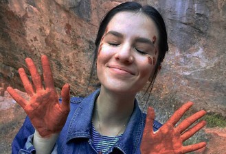 At Zion National Park in Utah, on the hike to the emerald pools, there are various sources of water which turn the mud in the park a clay-orange. It was almost impossible for me not to play with it. To commemorate the beauty, I asked one of my hiking partners to draw on my face with it.  Photo Credit: Ciprian Nedelcu
