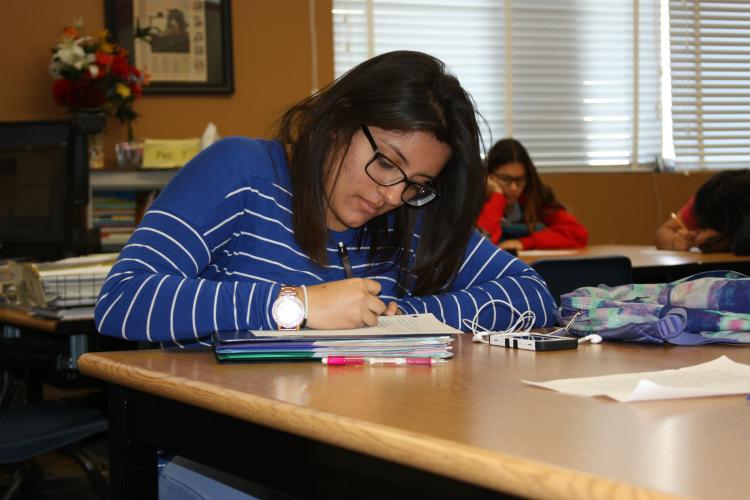 Following along to the speaker in her packet is sophomore Viviana Orizco. Listening and taking notes on her packet help Orizco understand the material.