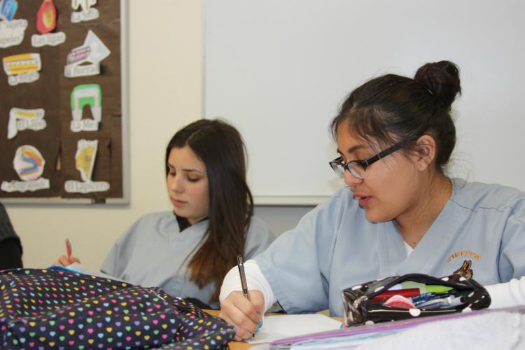 Listening to a phone call and writing down what the caller says are sophomores Estefania Cabral and Paulina Grijalva. In this activity the students must listen the call and write each word down word for word. "I learned that the Spanish language is such a beautiful language in that it can mean so many different things. The amount of detail in this story is incredible," Grijalva said.