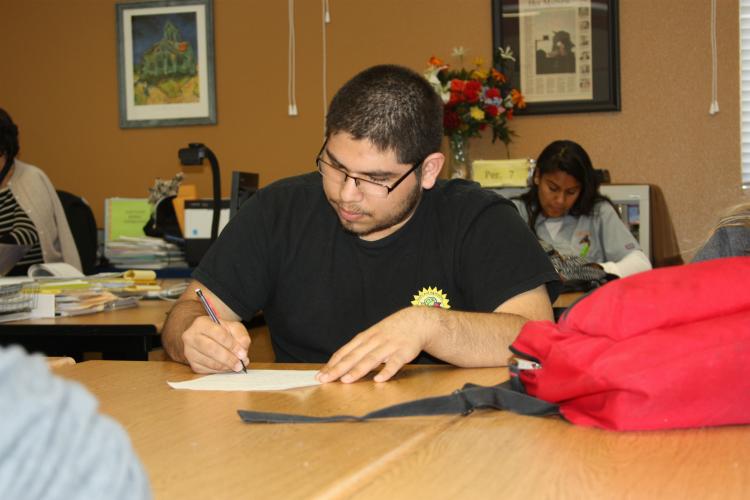 Taking notes on the story that is being read is senior Gabriel Vergata. With his highlighter in hand, he is ready to take notes and study them later.
