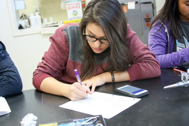 Sophomore Gabrielle Medellin writes down her thoughts on the presenters and their experiment.