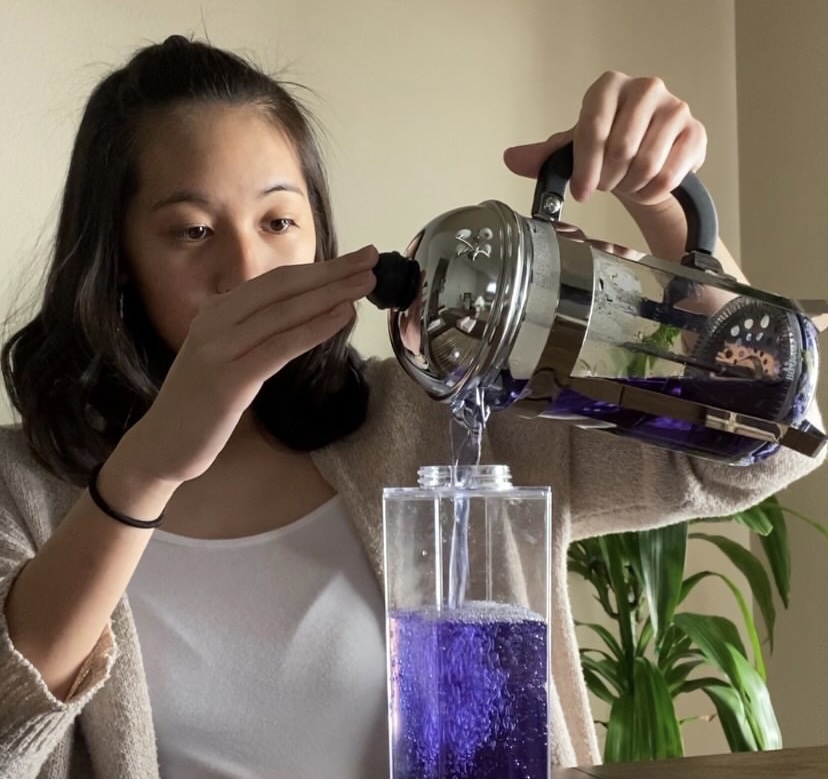 After junior Gabrielle Bagtas cold brews Butterfly Pea Flower tea, she pours it into a plastic cup. She focuses on adding the right amount of flavors to enhance the taste of the tea. “I really love changing up traditional and herbal teas into drinks that are more modern,” Bagtas said. “I think out of all the tea experiments I have done, I love making the color-changing tea.” Photo Credit: Gabrielle Bagtas