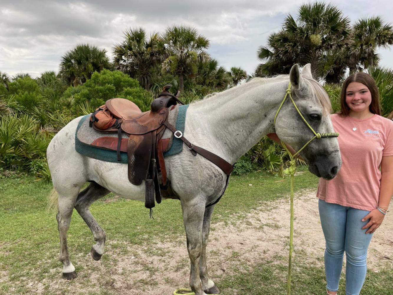 While vacationing in Florida, sophomore Madison Davis takes a ride with a western horse on the beach. With her experience, Davis has been able to connect with many horses in order to ride. “I was celebrating my birthday by going horseback riding during the middle of a hurricane, Davis said. The weather was aggressive considering the fact that I was super close to the beach.” Photo Credit: Madison Davis