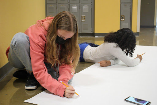Working on designing posters, freshmen Brianna Scherschel and Isela Michael sketch out their ideas in pencil. Student Council has been working in committees to prepare for Homecoming on October 22 and 23. “I am really excited that we get to have [a homecoming] just in general,” Scherschel said. “The past year and a half, two years, we haven’t had anything, and this is our first big dance back. I’m really excited for not just the dance but everything that comes with it, like all the sports and the posters and spirit week and that sort of fun stuff. Photo Credit: Juliana Borruso