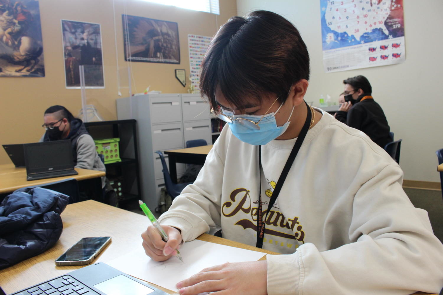 Working on his political cartoon, junior Anthony Pham expresses his ideas and opinions on the War of 1812. Students in APUSH had to create cartoons for their peers to view and interpret. “I’m excited to be able to represent and analyze political cartoons,” junior Anthony Pham said. “Its important to know how to make them since we should know the history and the process behind them.” Photo Credit: Ashley Harris
