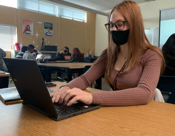 Signing up to volunteer for the final exam project sheet in English 101, senior Regan Thomas begins creating her rubric. Students can decide which organization they would like to volunteer for or send a care package if they chose to do outreach. “For this project, I decided to reach out to the Juvenile Diabetes Research Foundation. This organization raises money and awareness towards people living with type one diabetes,” Thomas said. “I am really excited for this project because I love getting involved with the community and giving back through community service. I know with this project I will positively impact a large number of people and make a true difference in this community.” Photo Credit: Gurleen Swaich
