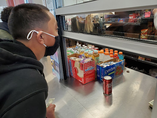 Ordering a snack from the student store, sophomore Kayan Galan waits to enjoy his lunch.  Students have been using the adjusted lunch schedule for about a week now. I think [most people like the new lunch schedule], but some of my friends dont really agree with it, Galan said. I think a lot of people like it.