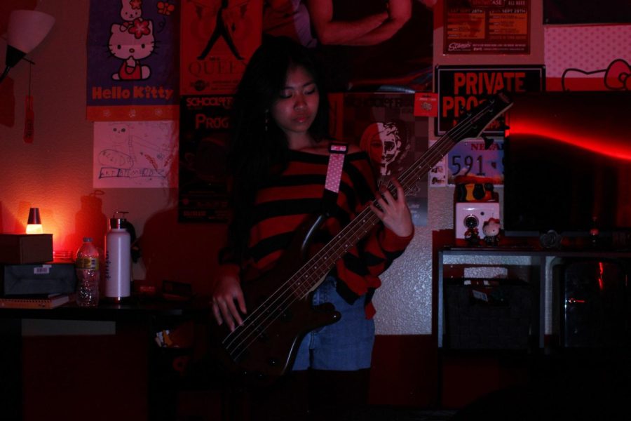 Practicing+her+bass%2C+Poselero+finds+a+new+bass+line+for+her+band%E2%80%99s+new+original+song.+Writing+her+own+content+has+always+been+a+great+way+to+express+her%2C+and+her+band%E2%80%99s+creativity.+%E2%80%9CIts+really+cool+to+see+when+I%E2%80%99m+on+stage+and+how+people+are+taken+aback+because+of+my+height%2C%E2%80%9D+Poselero+said.+%E2%80%9CPeople+don%E2%80%99t+expect+this+tiny%2C+little+lady+to+be+screaming+her+lungs+out.+My+energy+is+completely+different+than+if+I+were+to+just+be+talking+to+someone%2C+and+I+fell+in+love+with+what+that+felt+like.%E2%80%9D