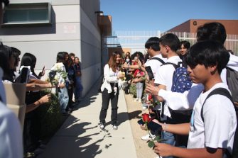  Anticipating a homecoming proposal, junior Danika Marie Molina exits the campus amongst a crowd of her peers as they cheer her on. The proposal, which had been planned for several weeks, attracted a crowd that numbered more than 50 spectators offering gifts and support. 
