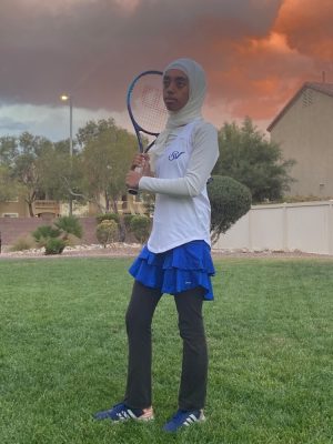 Holding up her tennis racket, sophomore Ihsan Seman finishes out a great tennis season. She made many new friendships while still donning her hijab proudly. “I came to play every single day,” Seman said. “I wasn’t forced to do this. I’m dedicated to this sport, and I want to be there.”
