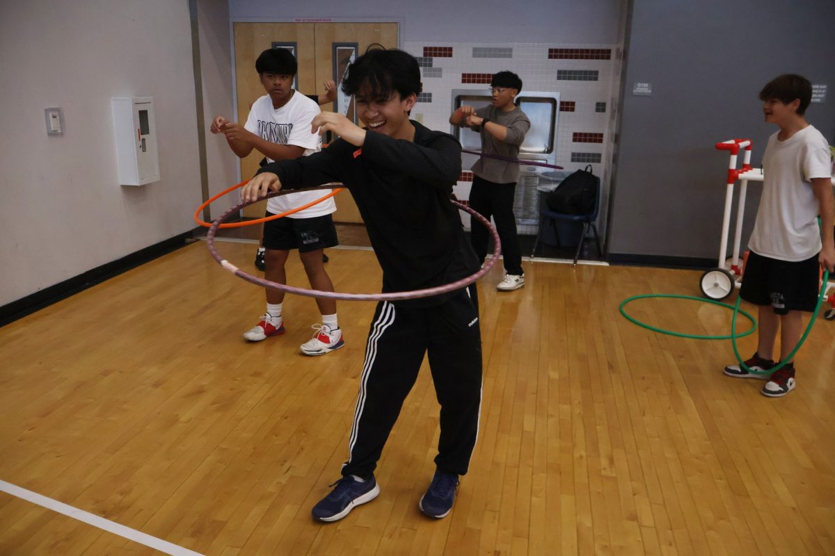 Swinging his hips, sophomore Matthew Pamaran wins a hula-hoop contest and gains extra points for his team.
