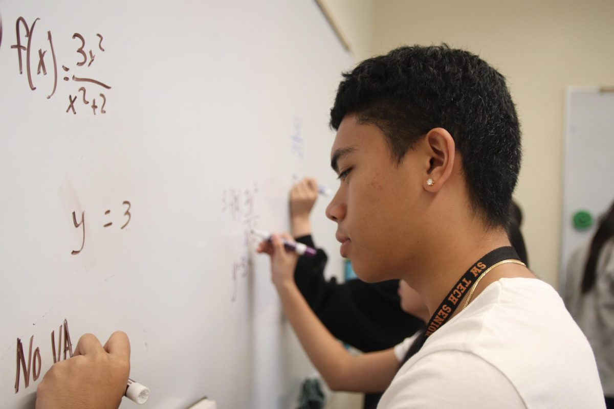 To prepare for the AP test, senior Andre Aquino is working out problems on the white board. He’s been practicing these problems for many weeks now, and thinks that he’s going to do well with the help of the teacher. “I think it’s definitely a very energetic way of teaching,” Aquino said. “I feel like it does get me ready for Calculus. I feel very awake when I’m in this class.”