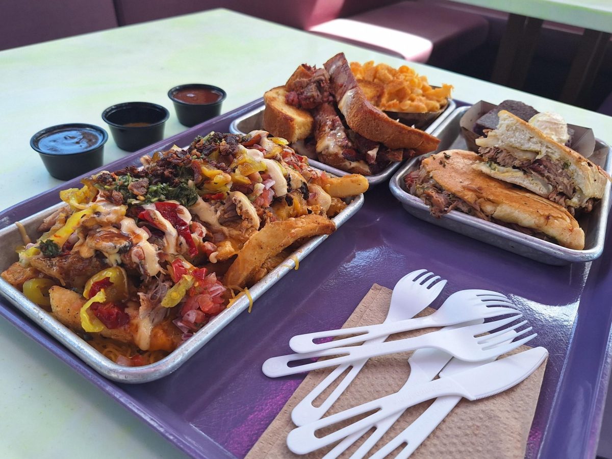 Photo of the entire meal, (excluding the cobbler desert). On the side, there is the restaurant's three signature barbecue sauces.