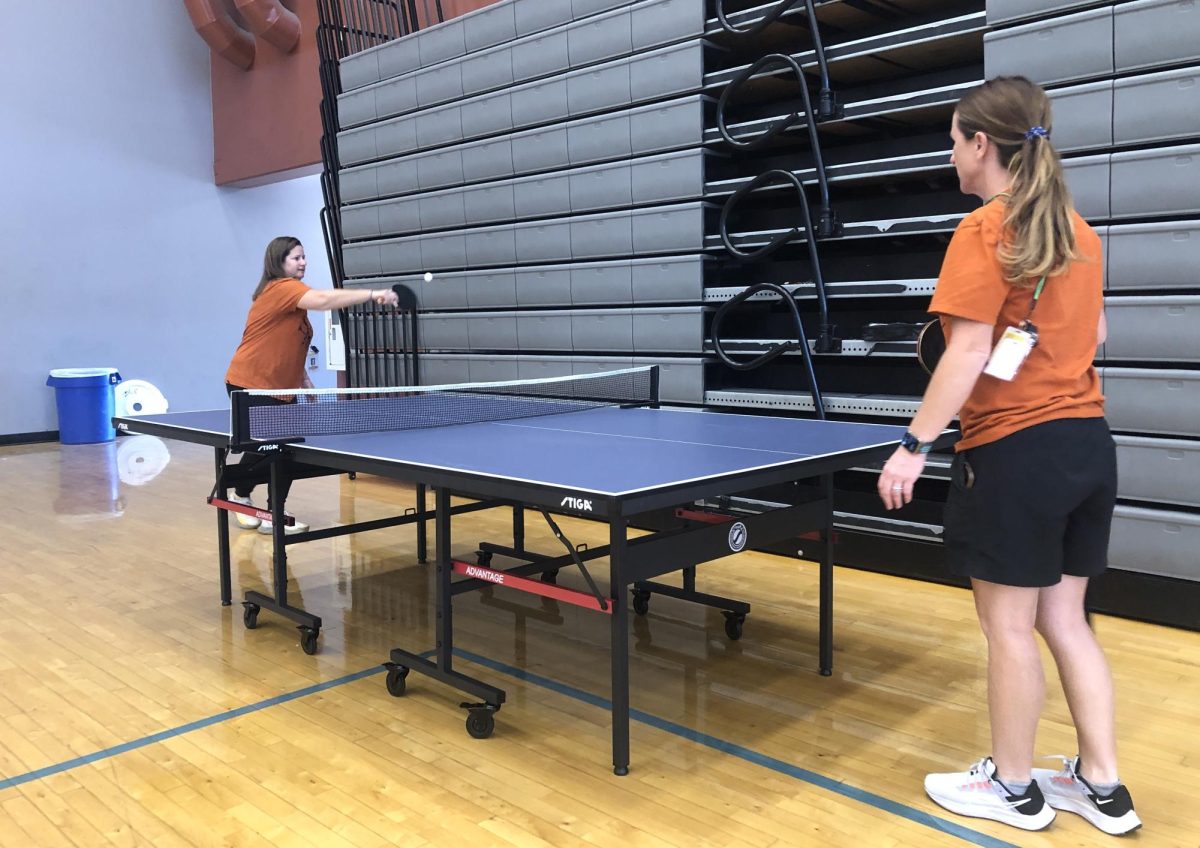 Playing on their newly purchased Ping Pong table, PE coaches Anne Kalenowicz and Michele Schmitt rally back and forth. Other pieces of equipment were also ordered to encourage students to exercise. “These are activities that they can continue throughout life,“ Schmitt said. “Our job as a teacher is to introduce them to all these different games so that they have options going forward in terms of working out and such.”