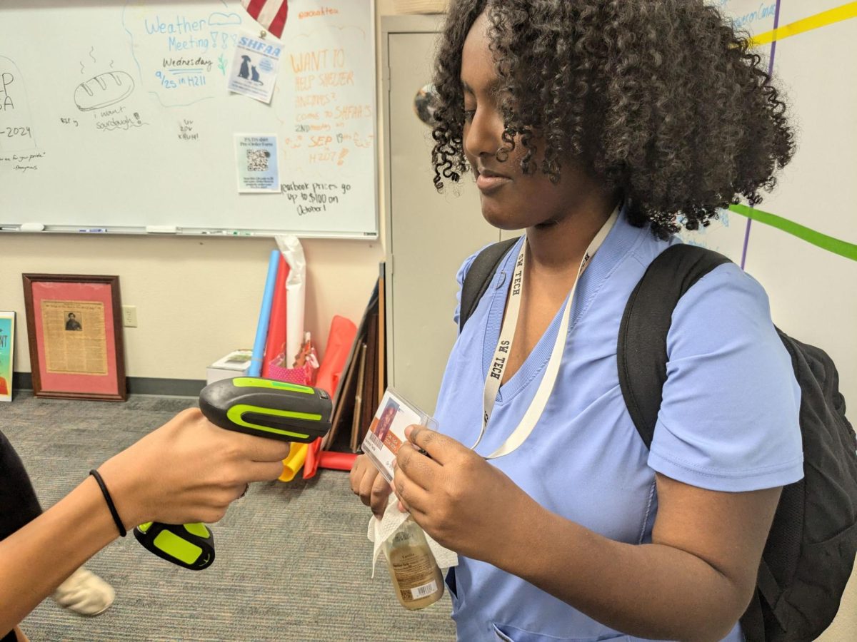 Scanning into her AP Human Geography class, sophomore Hareyna Tecle holds her ID up to the scanner. The scanners have been introduced in most classes since last Friday. “I feel like it’s productive,” sophomore Hareyna Tecle said. “It’s a really great idea; it’ll be a nice way for us to check in and for teachers to do attendance, more easily and more accurately.”