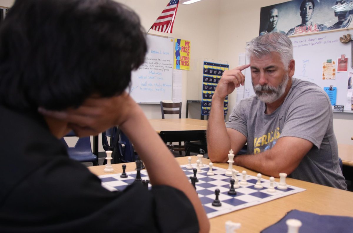 Helping the team practice for their next match, club adviser Jose Gomez thinks about his next move on the board. The team will be playing Sierra Vista HS for their next game on Tuesday, October 22. “There are lots of kids at other schools that are at a high level, but so do we,” Gomez said. “It just comes down to how long you have played the game for. I think practicing on the daily, even for just thirty minutes, helps a lot in terms of gameplay.”