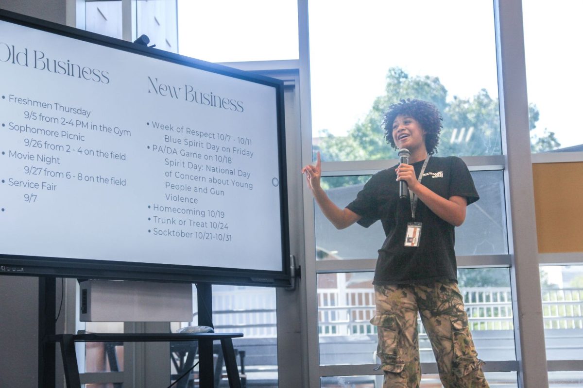  Announcing future school events with interest, junior Selena Lay Hamilton is hosting the meeting for the audience. She hadn’t done this before, so she was trying her best and was very energetic. “I was very nervous,” Hamilton said. “But overall, I was excited and had a good time hosting.” 