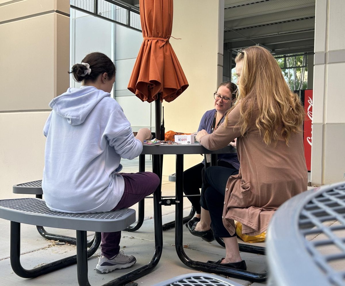 Social worker Marcella Garcia and SEIF Maura Staten work together to build a jigsaw puzzle with a student. They both engaged in conversation with the student fostering a calm and supportive environment.  “We don't want to add too much pressure,” Garcia said. “[Students]  already have a full schedule and things that [they] have to do, and so we want to make sure that principals patio doesn't add to the pressure of having to get things done. We really do want to try to keep it as unstructured as possible in a safe way.