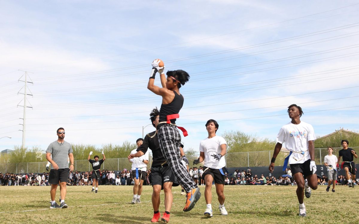 Catching the football, last year's Design Academy (DA) Senior Jayson Deguzman scores a touchdown for his team.  Following homecoming tradition, the Professional Academy (PA) and Design Academy (DA) will compete in a flag football game at the assembly on Oct. 18.