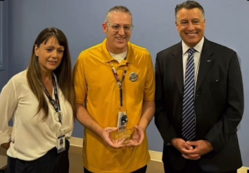 Standing next to Principal Donna Levy and UNR President Brian Sandoval, psychology and US history teacher Benjamin Lacombe showcases his new award. Lacombe received this award while teaching a class to the excitement of his students. “We were giving him a round of applause,” junior Valentina Escobar said. “I really think he deserves it.”