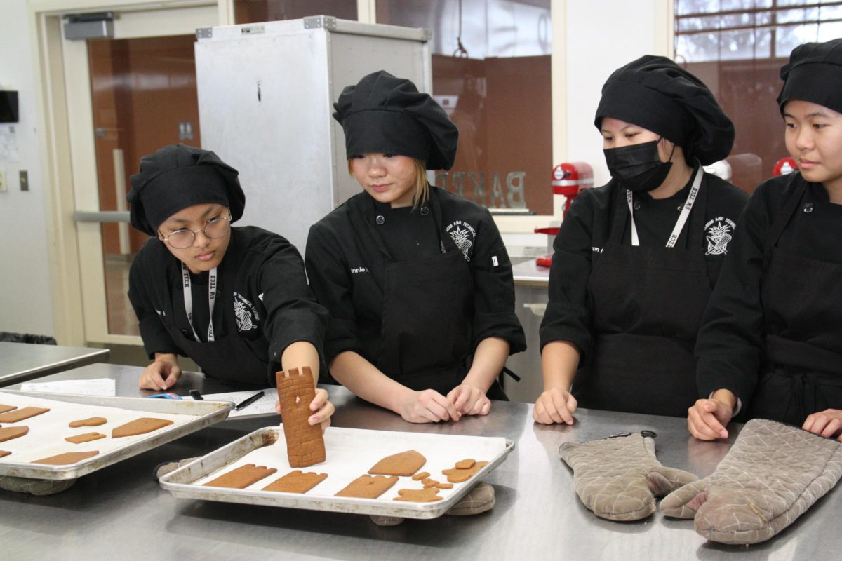 Carefully arranging their gingerbread design, sophomore Ariana Bognot and her team are making sure that their design is to their standards. ”Because they’re gingerbread houses, everyone in the group needs to collaborate and agree on the design and assign tasks so everyone isn’t working on just one thing,” Bognot said. “For the baking part, it’s great for creativity because it’s mostly for looks since no one’s eating the gingerbread house.”