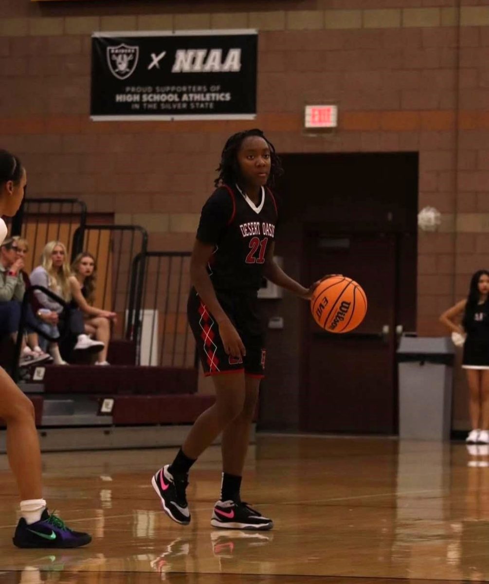 Dribbling the basketball away from the defender, sophomore guard Alyssa Atkins-Dowd looks for an open teammate to pass to. The game was between the Desert Oasis Diamondbacks and the Faith Lutheran Crusaders. “My family supports me playing basketball,” Atkins-Dowd said. “My dad is a basketball coach, and he, my mom, and my oldest sister, Nadia, always show up to my games. In every game that I have, there's at least one family member there supporting me from the bleachers, which I’m very grateful for.” (Credit: @dbacks_wbb)
