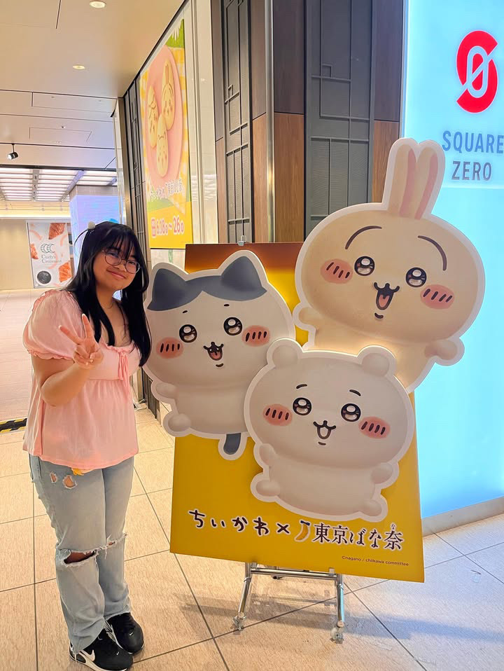 Posing with a Chiikawa stand, a popular Japanese cartoon character, junior Chloe Rivera enjoys her time in Japan. She snapped a picture with the Chiikawa and Tokyo Banana collaboration poster to commemorate the moment. “I think they [Chiikawa] were really cute and during the time I was thinking about how Tokyo Banana and Chiikawa collab and that I should take a picture before their collab ended,” Rivera said. “Sometimes I wish I got the collab package, but I’m also glad I didn’t even though the packaging is different.” 
“Photo Credit: Chloe Rivera”
