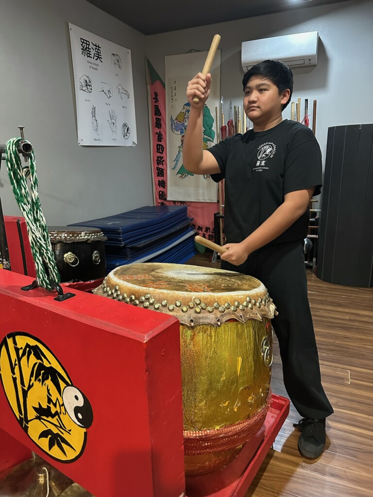 Elijah Cruz drums for the Lohan School of Shaolin. The rest of the team lion danced to match his beat. “It’s cool to see so many lion dancers move when I hit the drum and at the speed I want them to move,” sophomore Elijah Ray Cruz said. 