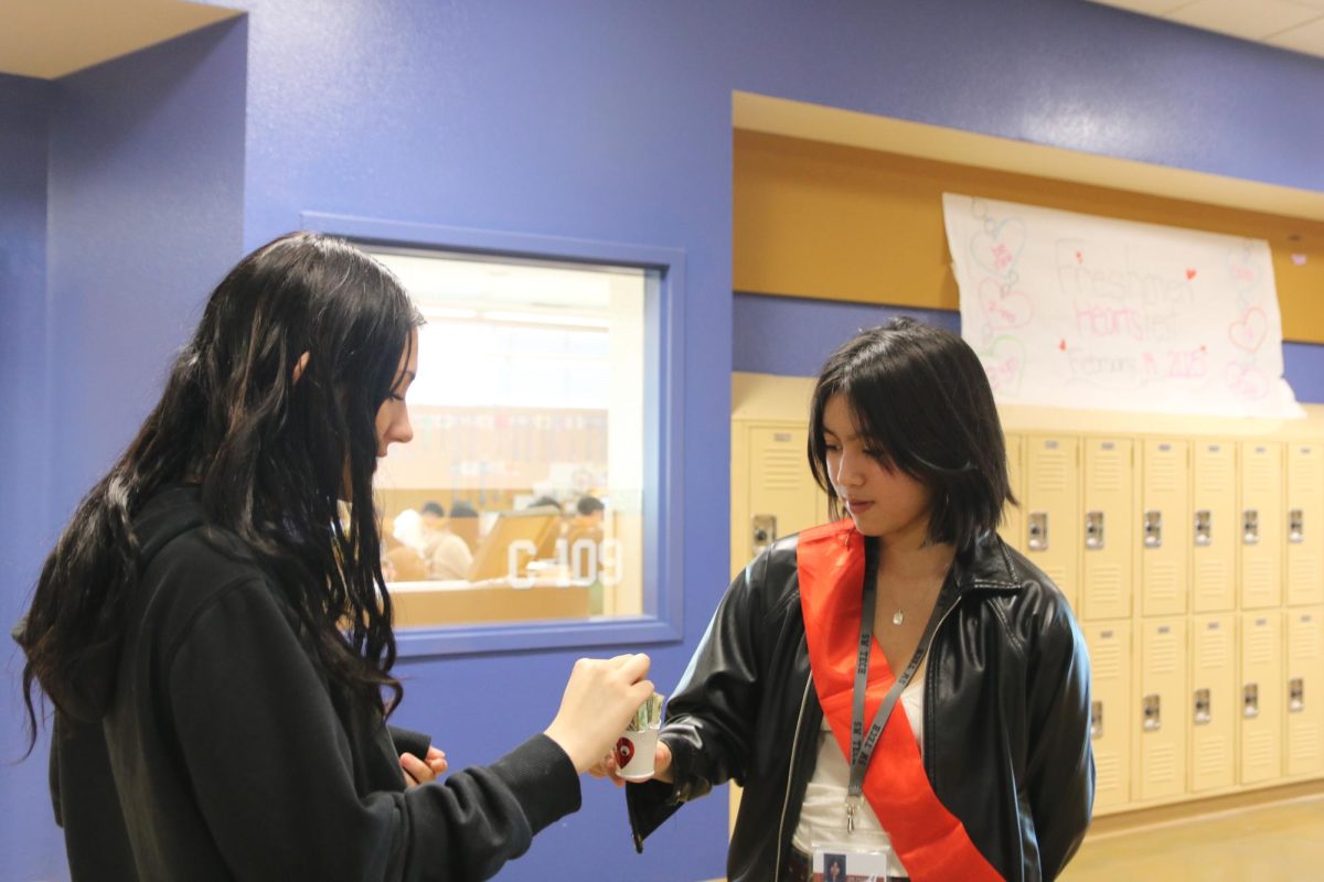 Collecting money for the King or Queen of hearts fundraiser, President of the Book Club Adrienne Vera-Perez kindly asks for donations. She asked students to donate before class to help raise money for the American Heart Association. “I really appreciate getting the opportunity to help raise money for the American Heart Association,” Vera-Perez said. “I think they spread awareness about an important cause and I like that I get to do this for my club too.” 
