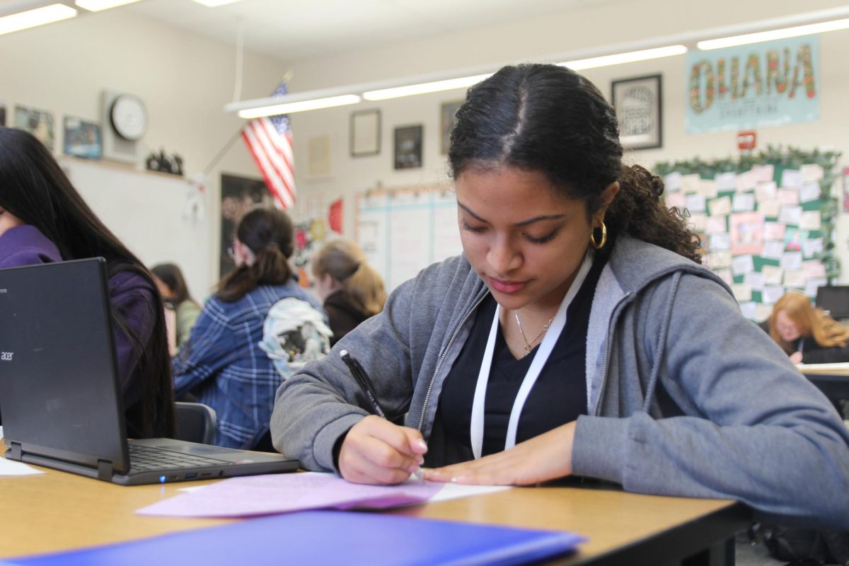 Practicing her educational philosophies, Teaching and Training II student sophomore Luna Rivera writes down her answers to the questions.  The upcoming field trip involves the basics of these philosophies to which it aims to help elementary students learn how to read. “I'm excited to get to go into classrooms and work with elementary students,” Rivera said. “It was something I was looking forward to ever since Ms. Penrod mentioned it.”