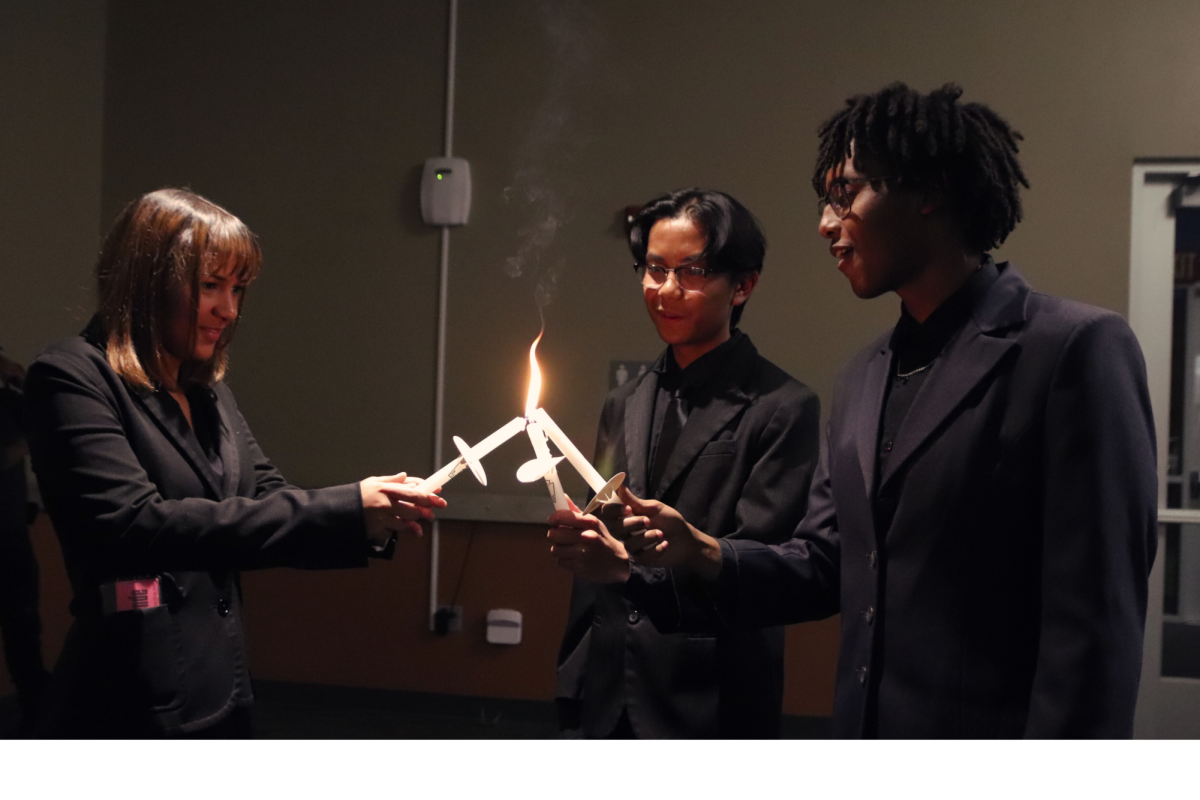 As part of the yearly tradition, Philipos Alebachew, Maximillan Aller, and Ava Nave came together to light their candles. This practice is done at every induction ceremony to officially welcome the students into the organization. “The candle ceremony signifies that when students are together, they bring a lot of light [to society],” NHS adviser Laura Penrod said. “Yet individually, they all bring their own unique light to the space.”