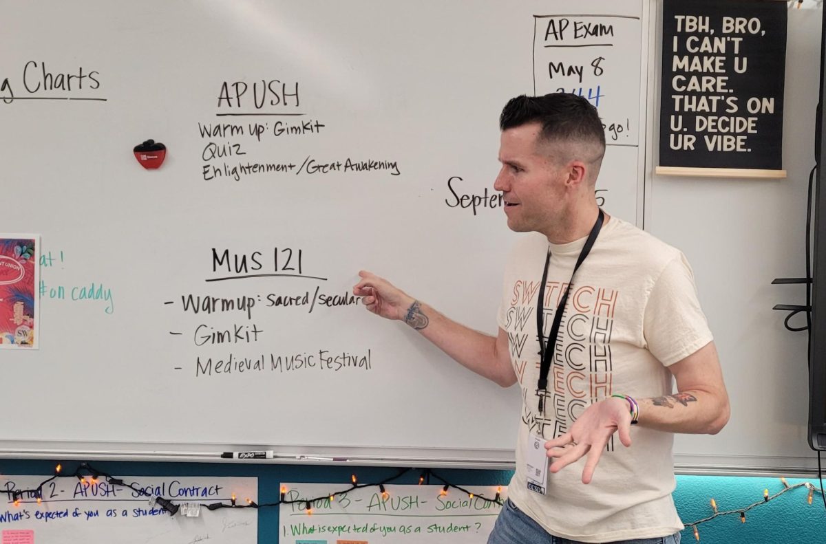 Ready to start class, Music 121 teacher Michael Woxland reviews the course’s daily agenda. Woxland believes his degree in music history has made him a perfect candidate for teaching this class. “It marries my two favorite things: Music and History,” Woxland said. “I was excited to find out that NSU offered a Dual Enrollment option for this particular subject. I was happy to bring another elective to campus that could help students get college credit.” 
