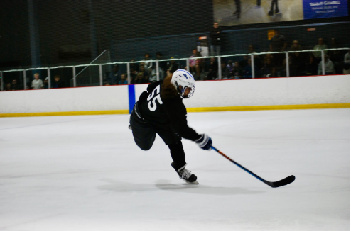 Erevis Sosniak, sophomore,  shoots the puck during a hockey match with his team, the Las Vegas Warriors. After a summer of devoted training, Sosniak performed a hat trick, or three goals for a single game, in his first match of the season. “It’s just my love of the sport. I love being out on the ice…I’ve been training myself to get lower and lower every time, it allows me to go faster because it creates a longer stride,” Sosniak said.