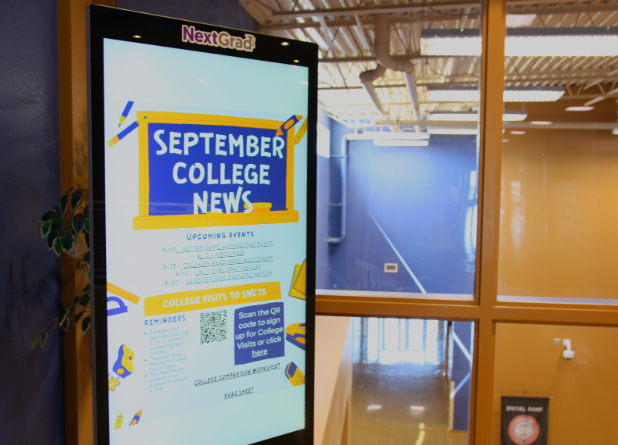 Displaying information about colleges and future planning, the NextGrad digital board in the Upper C building draws students' attention. Junior Khyle Colloma previously used the display to explore college options and plan his next steps. “It’s nice to have everything right here to help me figure out what my next step should be,” Colloma said. “I really like having the materials and resources to be able to decide.”