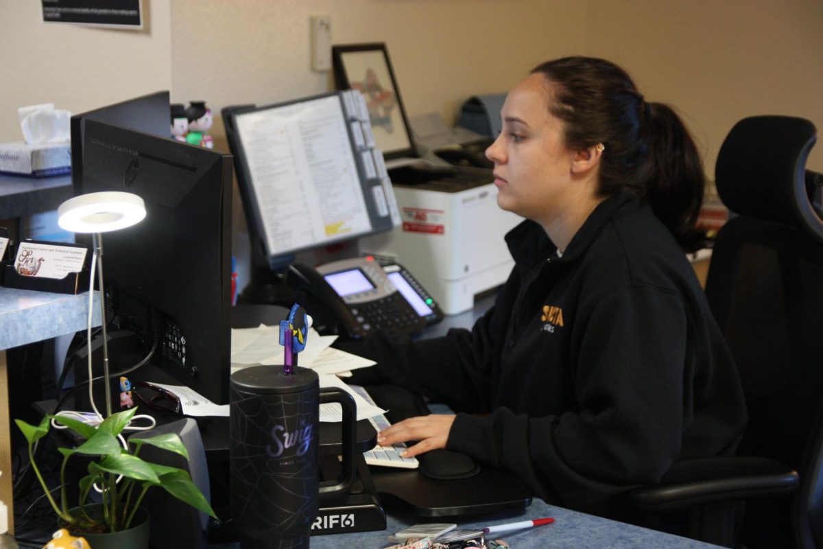 Working in the Student Success Office, Attendance Secretary Lordis Depiazza inputs a student’s absence excuse note. Students are required to bring an excuse note to the attendance office within three days of any absence. “Reminding students that being in school is important because it reflects towards your grades and being able to do any activities with the school,” Depiazza said. “[It] seems to get the students' attention about wanting to be in school.” 