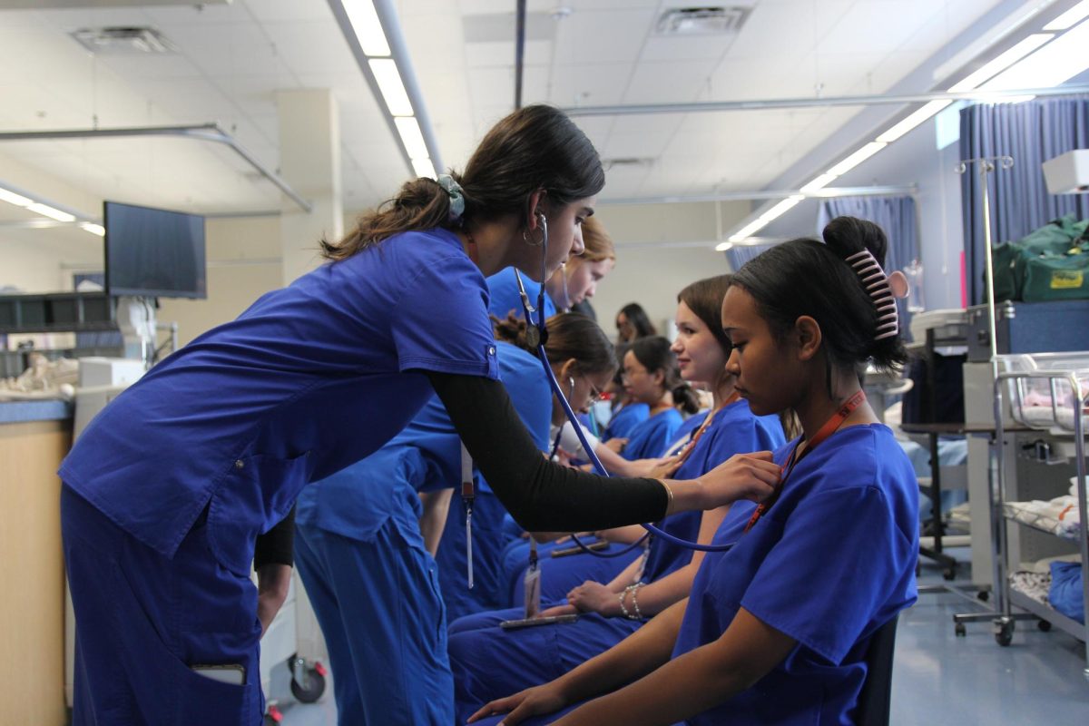 Practicing the basic skills of nursing, sophomore Natalia Yancey gets her heartbeat checked with a stethoscope. Sophomore nursing students reviewed skills from freshman year. “I’ve always wanted to be in the medical field; it’s been my dream forever,” Yancey said. “Doing [practice skills] so early on is not only an amazing opportunity, but it helps me to prepare for my future.” 