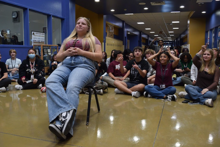 Sitting away from the crowd, Drama Club president Dylan Grove performs a prompt in an improv game. Members in the back had to guess what scenario she was acting out. “I’d say the first few rehearsals of a play are really enjoyable,” Grove said. “I find it fun to see everyone kind of struggling at first, but then slowly getting more comfortable and used to their roles.”