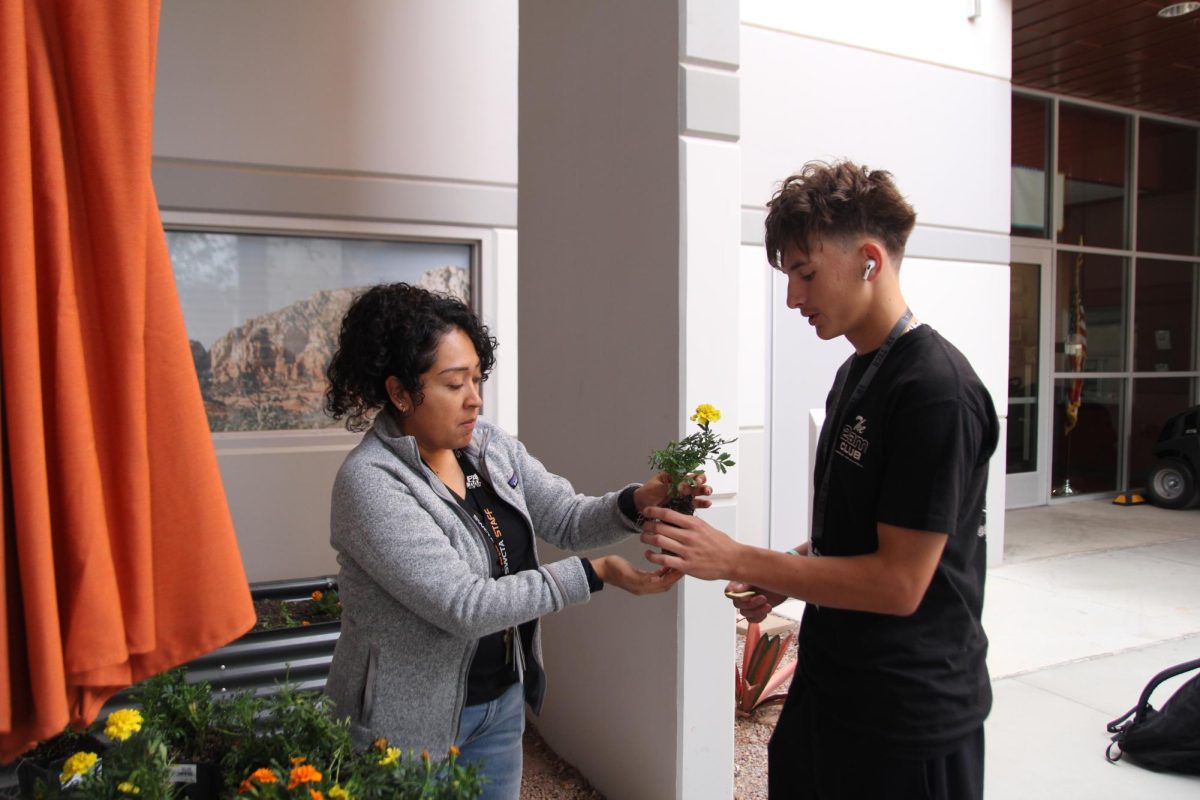 Students plant flowers to improve their mental health and wellness.