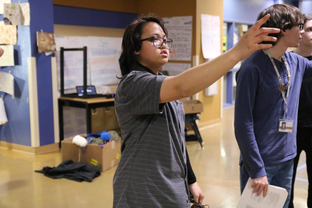Delegating directions to club members, Drama Club technician Shaela Manubag guides Drama Club members to their assigned role to meet the rehearsal expectations. “My job is running around testing out the microphone system and working with all the light equipment,” Manubag said. “It helps out with the mics and for actors to sound more clear by leading into the audio cues and knowing what is going on.”