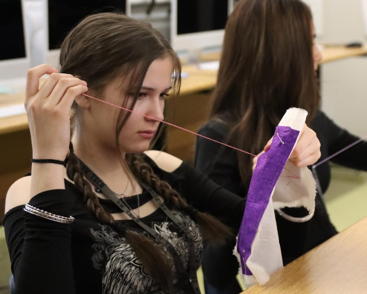 Finishing up a stitch, freshman Lana Salvic works on her quilt block. Students in Fibers I were each given personalized quilt pieces based on their skill level to ensure the project was completed on time. “The challenge was making unique quilt blocks for 32 to 24 students per class,” Fibers teacher Jennifer Gonzalez said. “I had to decide which student could handle which type of stitching for them to be the most successful, so it was very labor intensive. It took me five or six hours to prep for this project.”