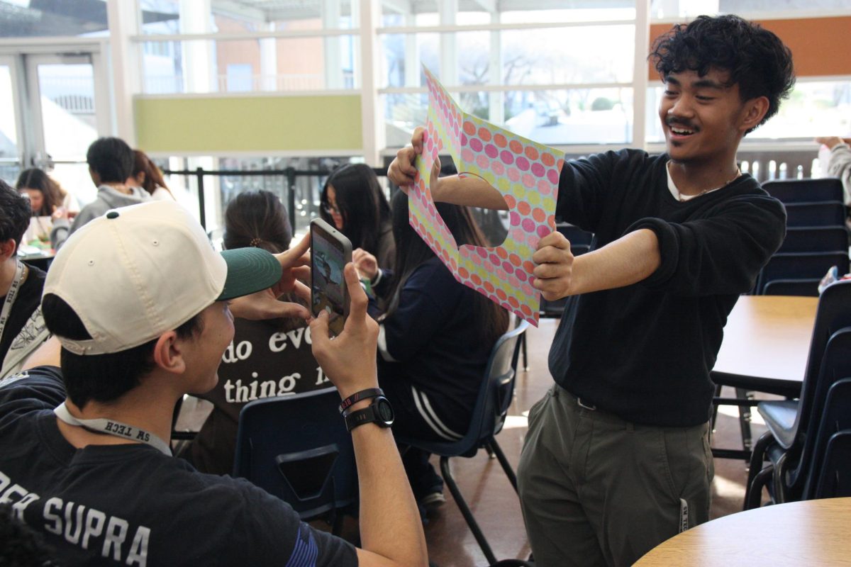 Posing with a heart-shaped cut out, junior Makoa Apao snaps a photo of junior Christian Reyes. “We were cutting out heart-shaped cards for the Valentine’s thing to give the teachers,” Reyes said. “I took the other piece that wasn’t the card and I was just imagining Makoa in it, making a joke.”