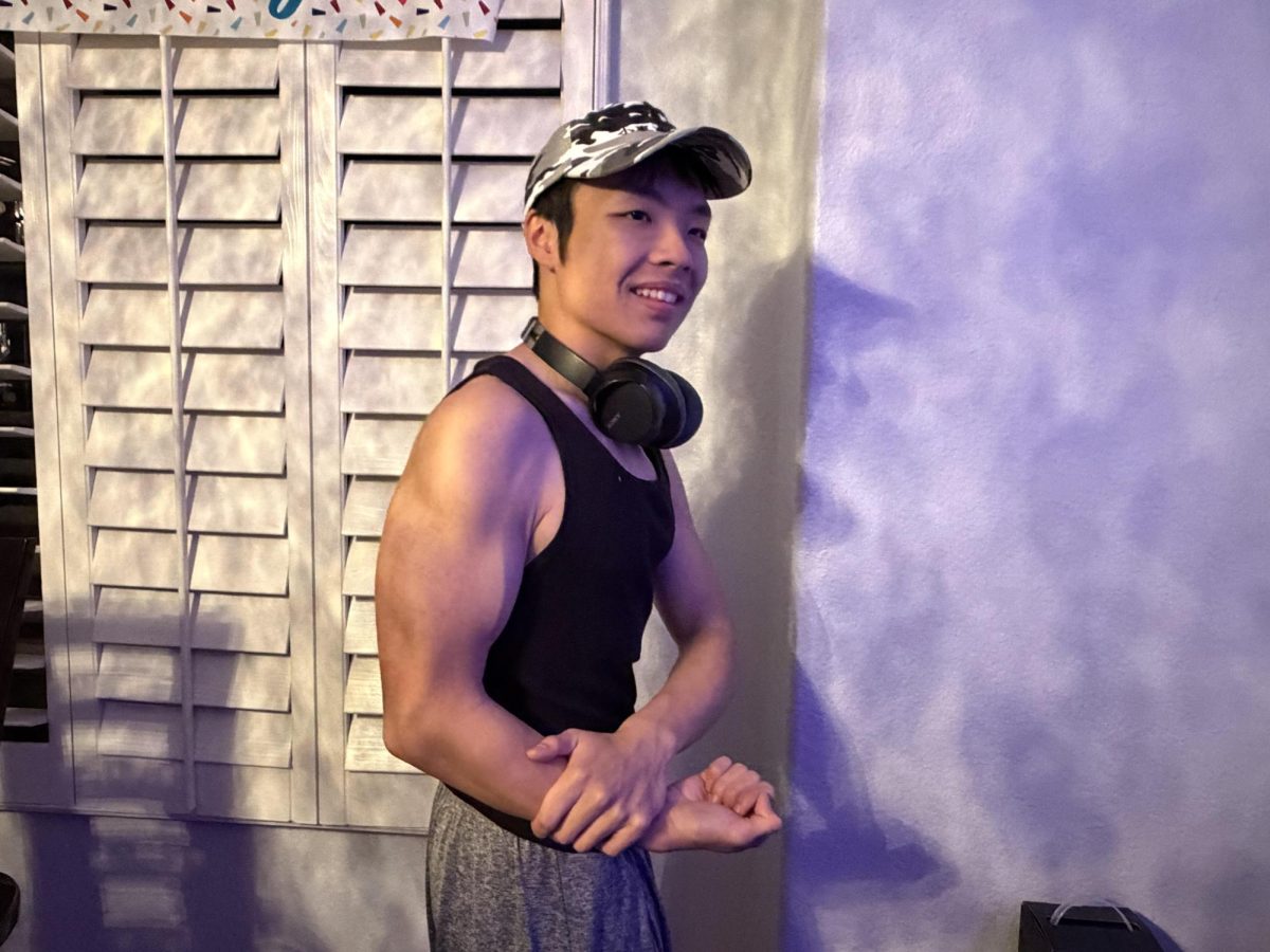Posing for a photo, senior Sebastian Huynh shows off his hard work. To maximize muscle growth, Huynh prioritized high-intensity in his training. “Studies show and from personal experience that lifting with a higher intensity, nearly towards failure, with your lifts, will often provide greater results than just going through the motions of a workout,” Huynh said. “That's one thing that I preach greatly among people.”
